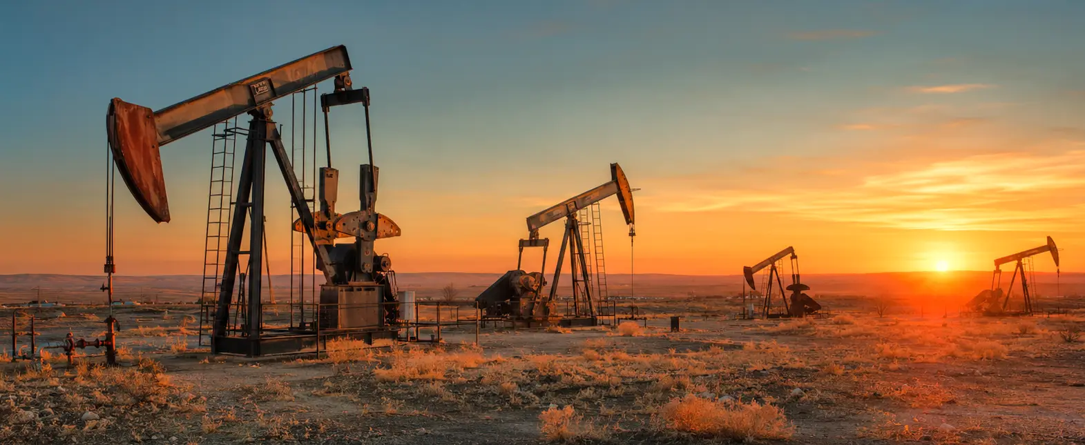 Oil field pumpjacks at sunset